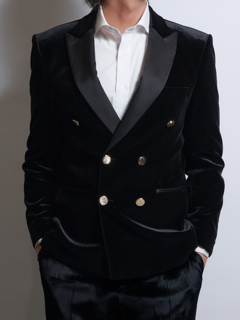ブラックベロアダブルジャケットゴールドボタンサテンカラーを着る男性