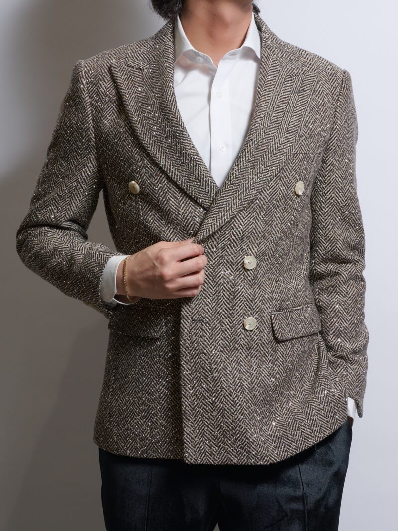 ブラウンヘリンボーンラインストーンダブルジャケットを着る男性